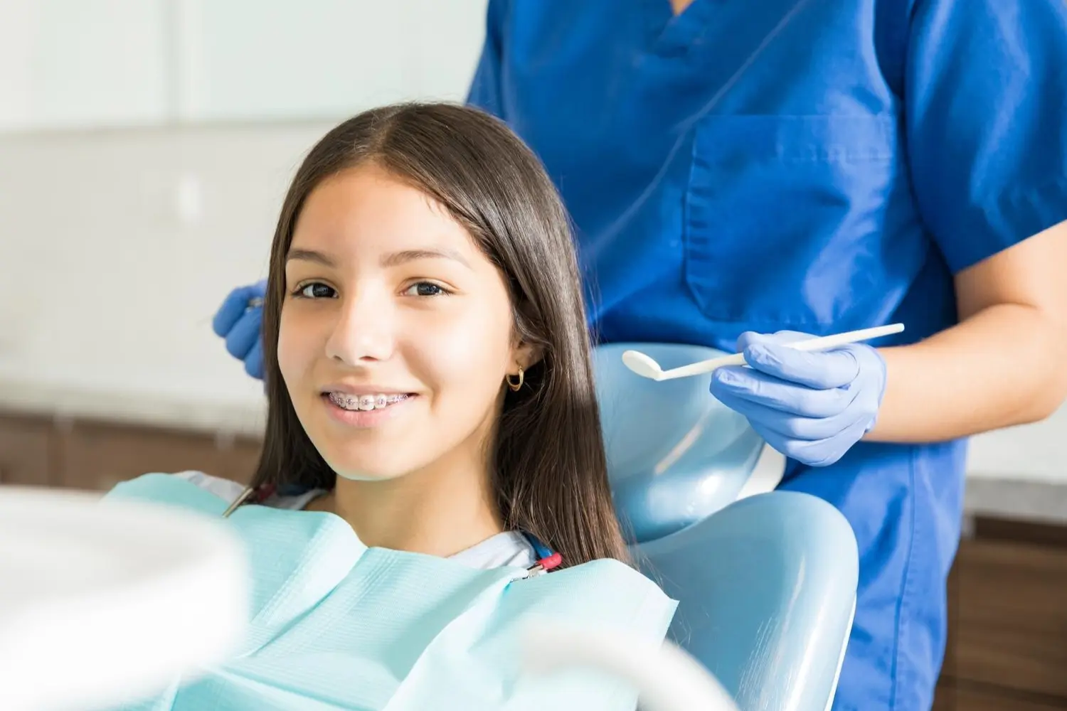 Orthodontist and a teenage girl patient